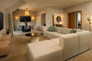 a living room with a couch and a table at Hilton Milan in Milan