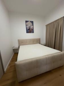 a large white bed in a room with a couch at Central nude oasis 2 in Makarska