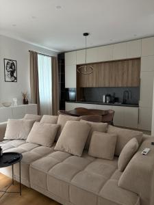 a living room with a couch and a kitchen at Central nude oasis 2 in Makarska +10 photos