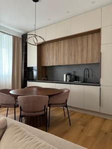 a kitchen with a table and chairs in a room at Central nude oasis 2 in Makarska