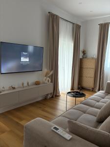 a living room with a couch and a flat screen tv at Central nude oasis 2 in Makarska