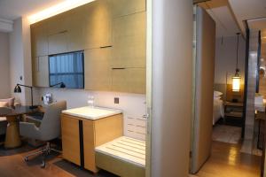 a room with a desk and a table with a chair at Shanghai Marriott Hotel Kangqiao in Shanghai