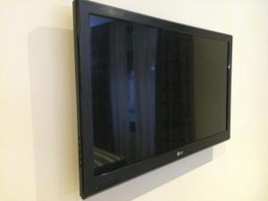 Televízia a/alebo spoločenská miestnosť v ubytovaní Hotel Alameda Málaga