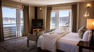 a hotel room with a bed and a large window at The Lofts Boutique Hotel in Knysna