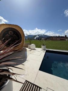 a swimming pool with a view of the mountains at Alpen Sky Suite Flachau in Flachau