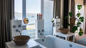 a bathroom with two sinks and a large window at The Lofts Boutique Hotel in Knysna +113 photos