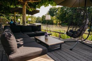 a living room with a couch and a swing at Hotel Mitland in Utrecht +139 photos