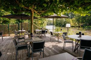 an outdoor patio with tables and chairs and umbrellas at Hotel Mitland in Utrecht