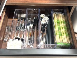 a drawer with knives and utensils in it at Room One in Aomori