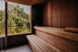 a sauna with a large window in a wooden room at Hotel Mitland in Utrecht