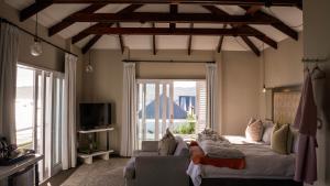 a bedroom with a bed and a large window at The Lofts Boutique Hotel in Knysna