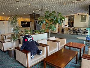 a stuffed animal sitting on chairs in a restaurant at Yatsushiro Grand Hotel in Yatsushiro