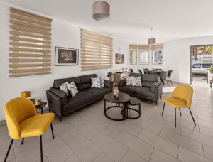 a living room with a couch and chairs at Villa Allegra in Protaras