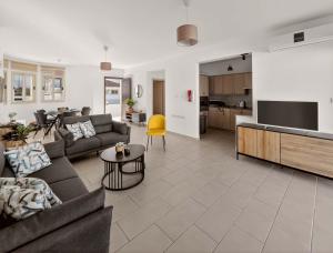 a living room with a couch and a table and a kitchen at Villa Allegra in Protaras