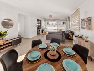 a dining room and living room with a table and chairs at Villa Allegra in Protaras