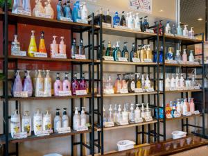 a room filled with shelves filled with lots of bottles at Yatsushiro Grand Hotel in Yatsushiro