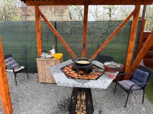 a outdoor grill with food on top of it at Casa SOL in Turda