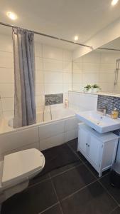 a bathroom with a toilet and a sink and a tub at Denkmal Rhens in Rhens
