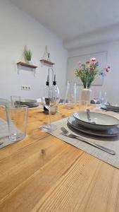 a wooden table with plates and wine glasses on it at Denkmal Rhens in Rhens +52 photos