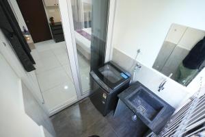 an overhead view of a bathroom with a trash can at Hotel Flamount Arka Studios in Hyderabad