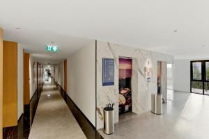 a hallway in a building with a sign on the wall at Sunshine Beach Layan by Beringela in Layan Beach +68 photos