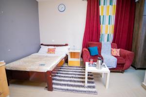 a small room with a bed and a couch at Vine Suites Mbarara - 1 Bed Studio Apartment Near LDC & City Centre - Quiet & Convenient in Mbarara