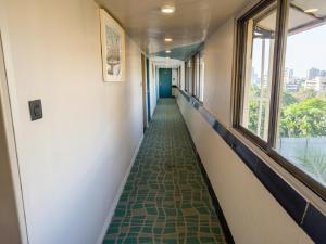 a corridor of a hallway with a long hallway at asar Elite by Orion Hotels in Mumbai