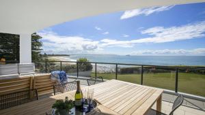 a balcony with a table and a view of the ocean at 'Aloha Beach Retreat' by HolidayCo in Norah