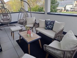 a patio with chairs and a table with a coffee table at Relaxsuite Serrig in Serrig