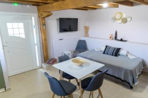 a bedroom with a bed and a table and chairs at RAVANIS Home in Áyios Pétros