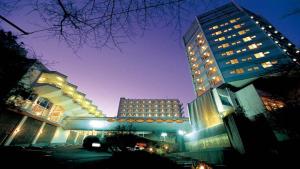 a large building with lights on it at night at Hatoya Hotel in Ito