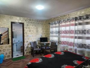 a bedroom with a bed and a desk with a computer at Hotel Pahalgam Villas in Pahalgām +28 photos