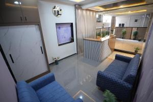 an overhead view of a living room with blue couches at Hotel Flamount Arka Studios in Hyderabad