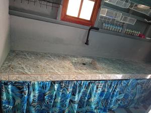 a bathroom with a blue and white counter top at Sarah House Rental in Clarin