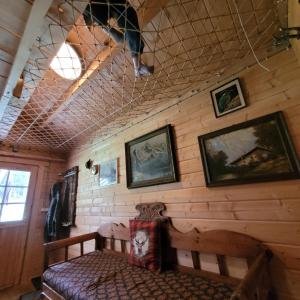 a room with a bench and pictures on the wall at Holzhütte allein am Waldrand in Saldenburg