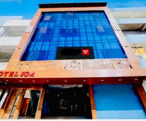 a building with blue glass on the front of it at Hotel 5G in Bhopal