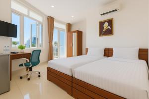 a bedroom with a bed and a desk and a chair at Lunar Stay HCM in Ho Chi Minh City