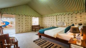a bedroom with a bed in a room at Desert Horizon Luxury Resort &Camp in Jaisalmer +18 photos