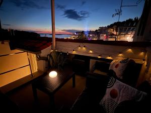 a balcony with a table and lights on a ship at Lavanda in Tribunj