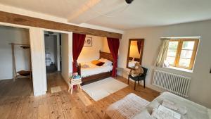 a living room with a bed and a couch at Villa Colombier in Pontgibaud