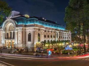 a building with lights in front of it at night at Lunar Stay HCM in Ho Chi Minh City