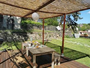 a picnic table under a pergola in a garden at Villa Colombier in Pontgibaud +13 photos