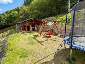 a playground with a swing set and a shed at Chalupa ALMA in Žacléř +11 photos
