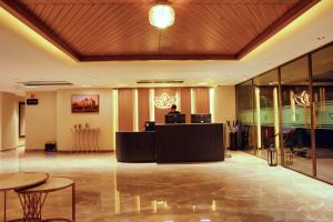 a lobby with tables and chairs in a building at Grand Continent Hotel, Near Sector 44, Gurugram in Gurgaon