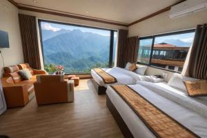 a hotel room with two beds and a large window at Sapa May Ecolodge in Sapa