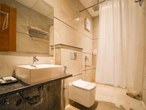 a bathroom with a sink and a toilet at Lemonade Hotel Alwar in Alwar