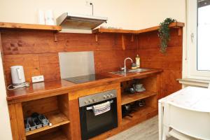 a kitchen with a sink and a stove at Pension Highway - Bielefeld Senner Hellweg 227 in Bielefeld