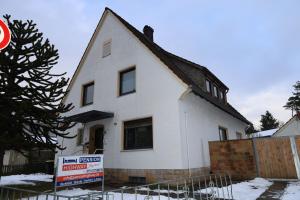 a white house with a sign in front of it at Pension Highway - Bielefeld Senner Hellweg 227 in Bielefeld