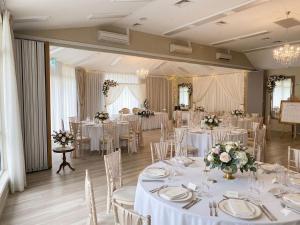 a banquet room with white tables and white chairs at Golf Place Inn Wollongong in Wollongong +61 photos