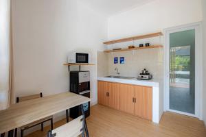 a small kitchen with a sink and a microwave at Cove Dahayu Sanctuary in Sanur +18 photos